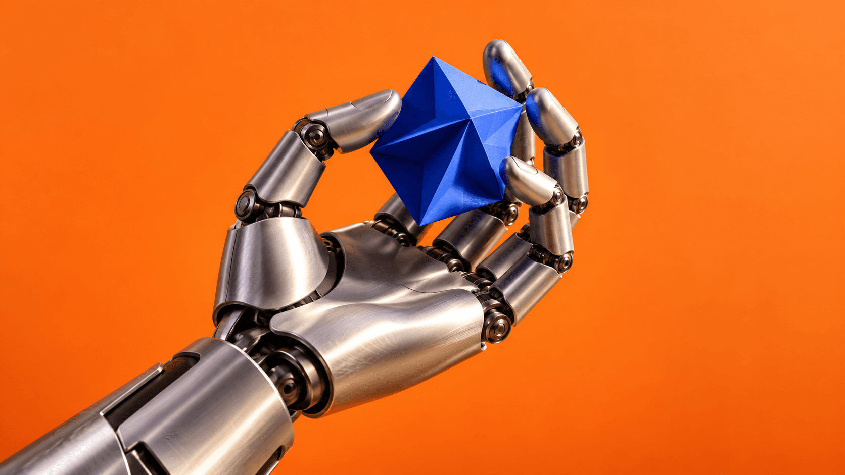 A stylized silver robotic hand holds a folded cobalt geometric object against a vivid orange background.